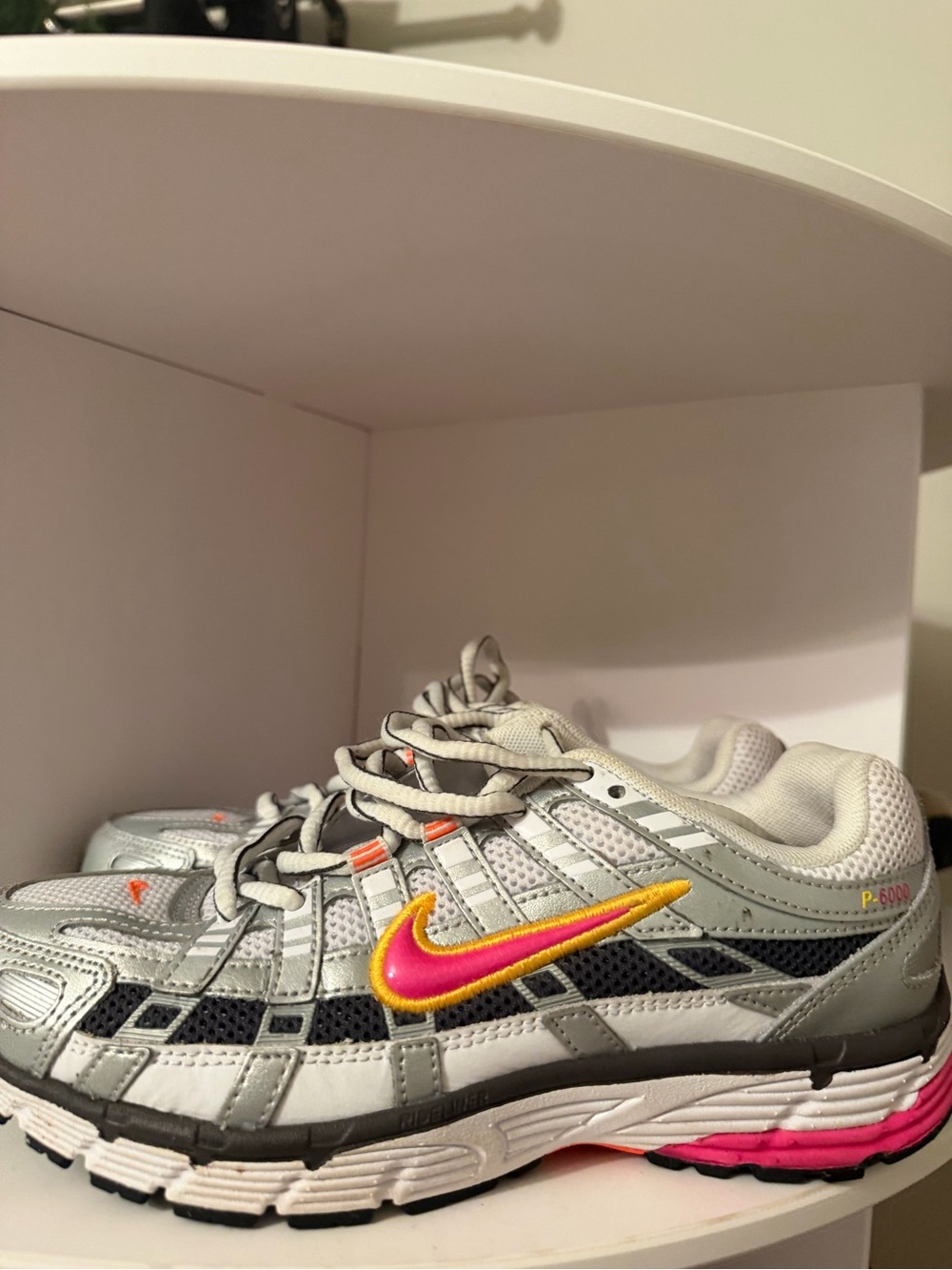 Nike Women's Silver Sneakers with Pink and Yellow Swoosh